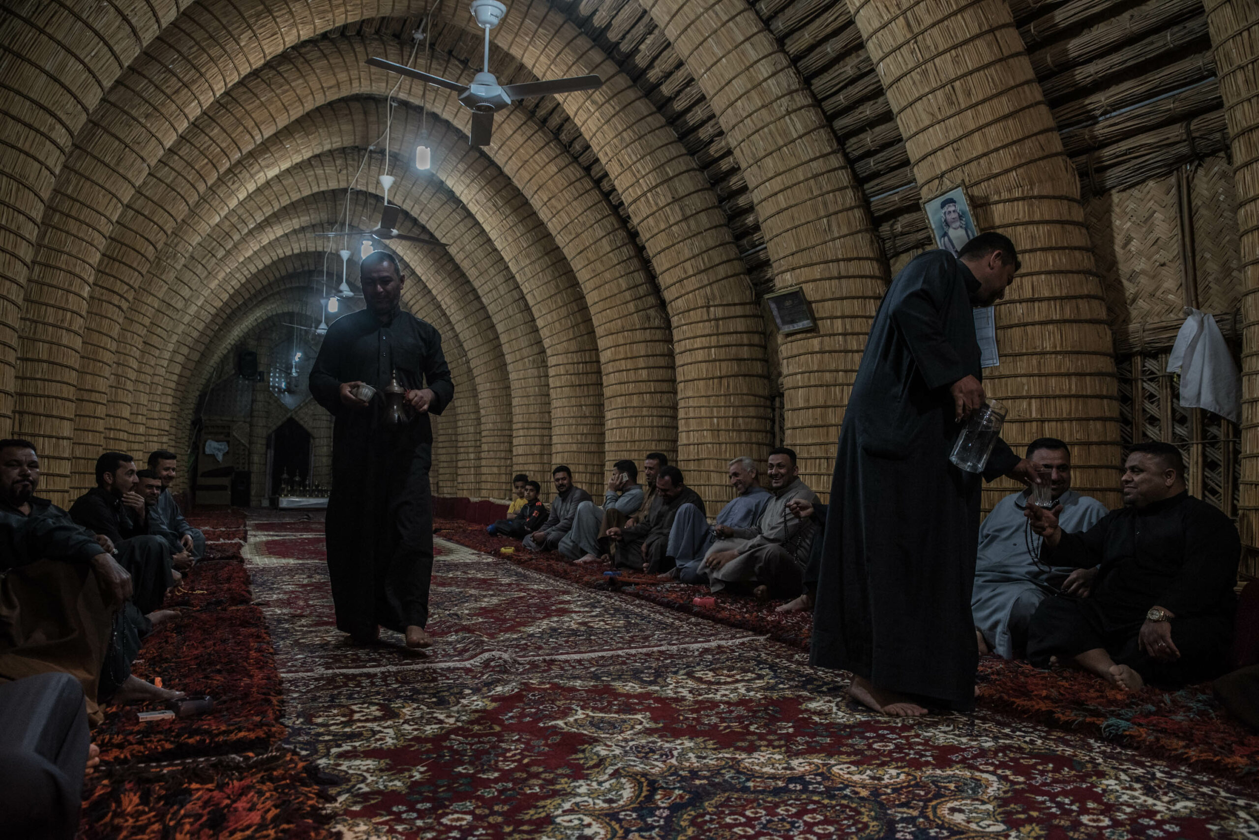 Local sheikhs are gathered in a mudhif (common house) around midnight in Chibayish. Women are not usually allowed in this "men only" place where men sit for hours, discussing local affairs and drinking tea and arabic coffee with cardamom.