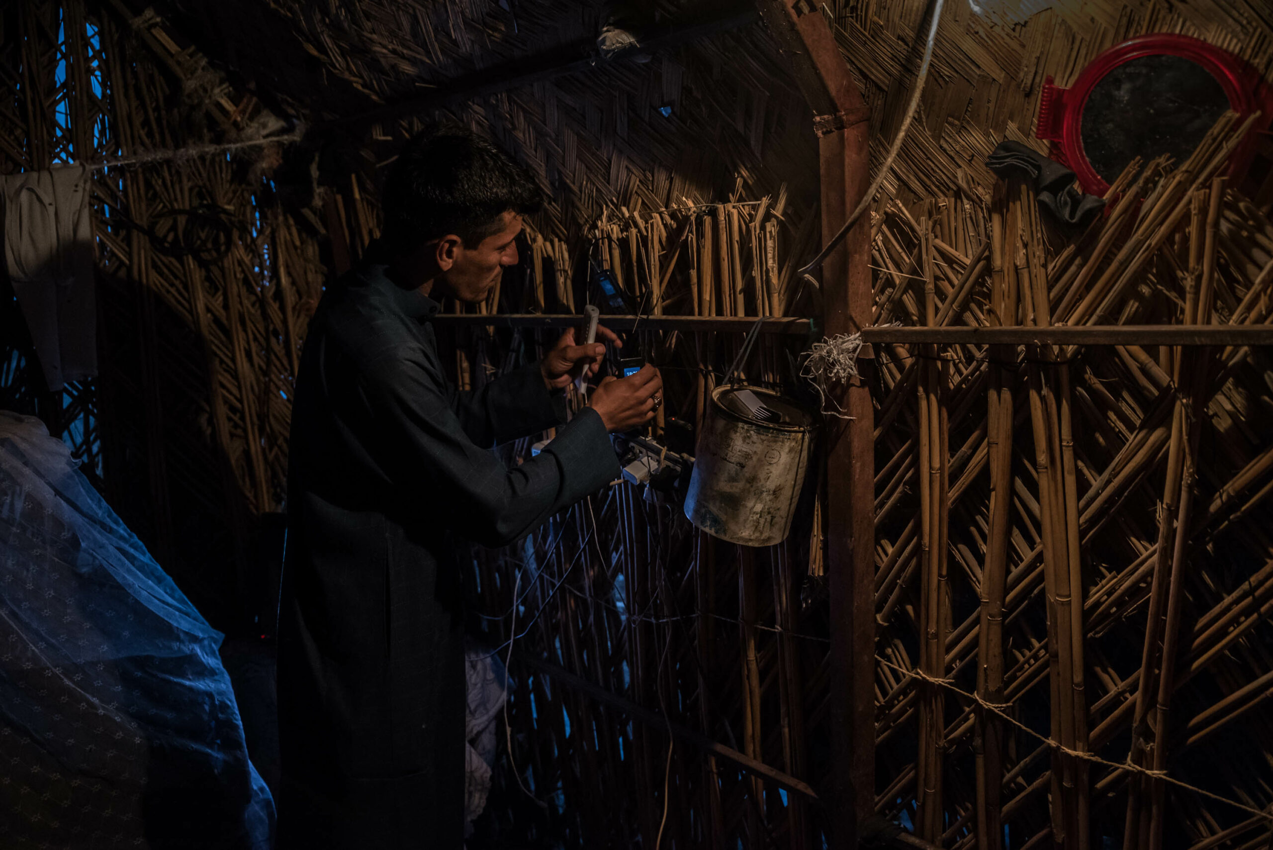 Ali Murad Hassan, alias "Sayeed" Ali, is trying to charge my phone in his reed house in Ishan Gubba, deep in the Central marsh. He has set up a generator outside his house that provides a few hours of electricity daily.