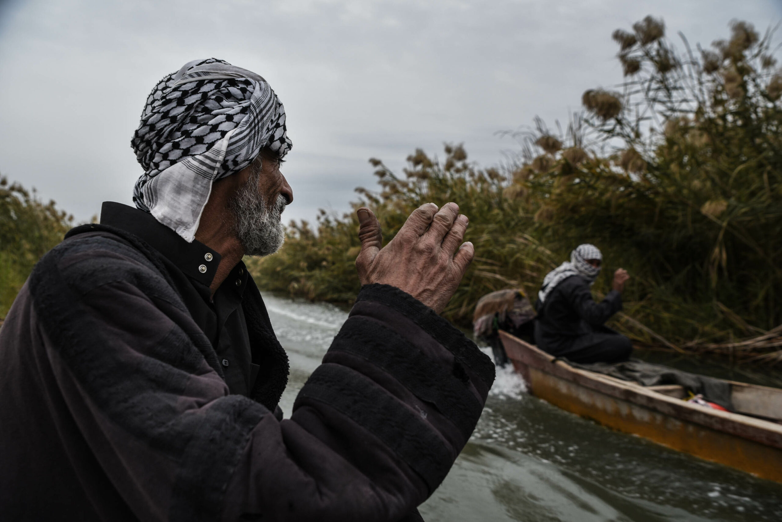 Abu Haidar is greeting another Marsh Arab in the Central Marsh, on a cold winter morning.